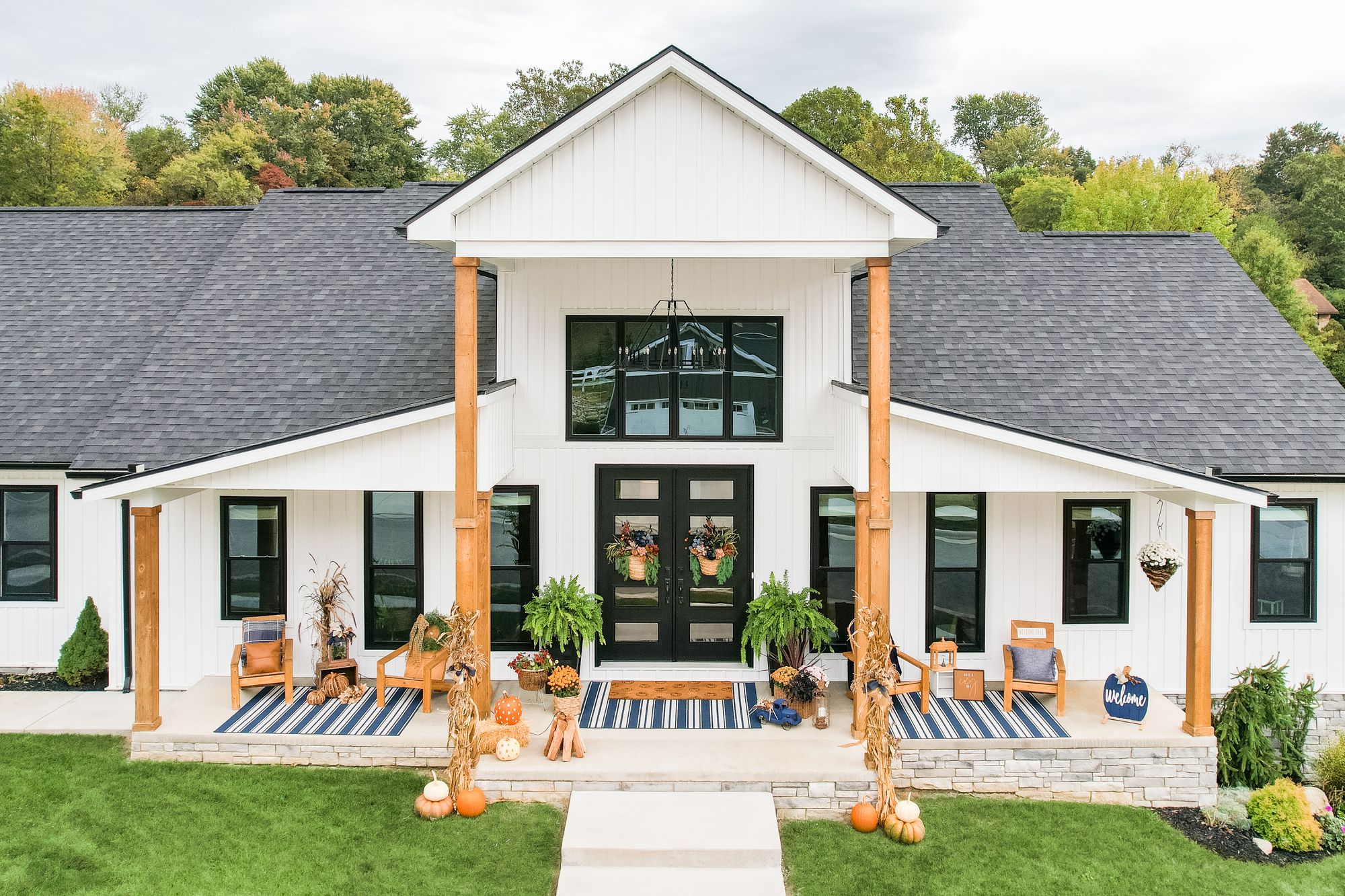 White modern farmhouse in Central Arkansas with black-framed windows and a double entry door