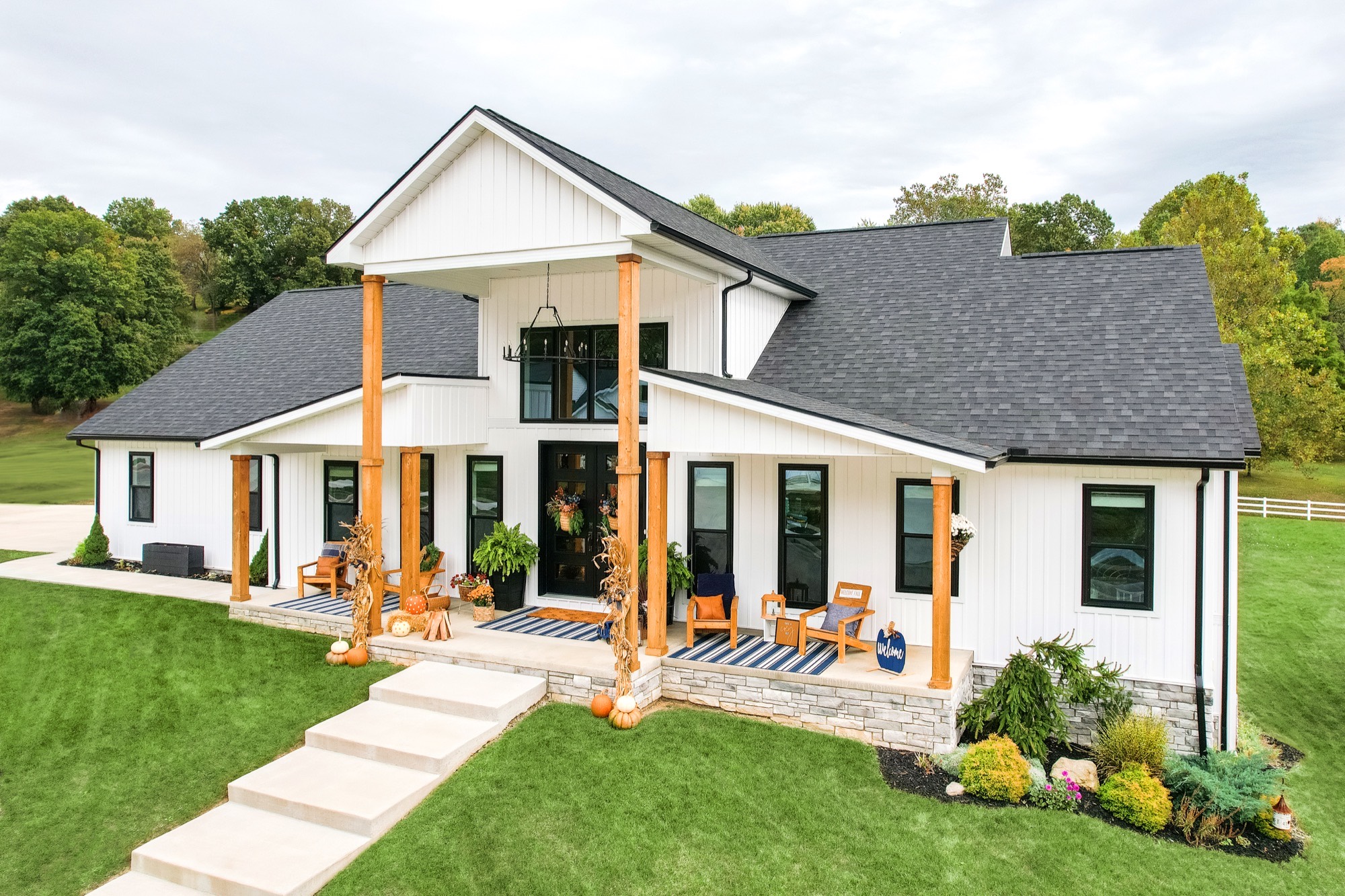 White farmhouse in Central Arkansas with new black double-hung and picture windows